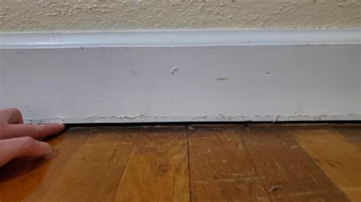 How much space do you leave under baseboard for carpet?
