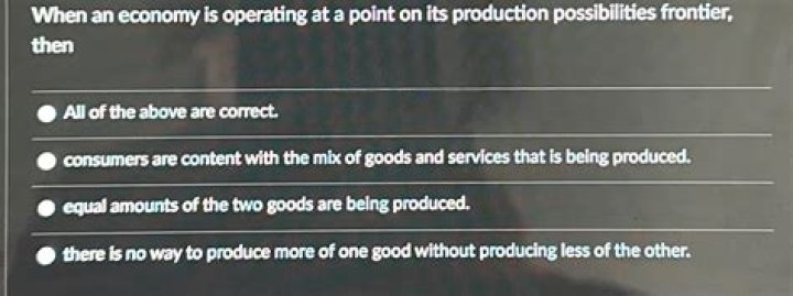 When an economy is operating at a point on its production possibilities frontier then?