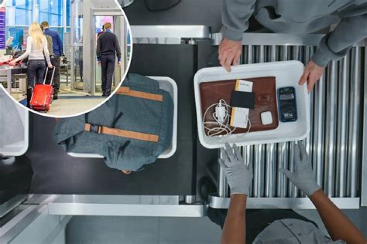 Where do you put your phone when going through TSA?