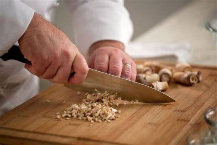 Why do chefs often tear rather than cut up lettuce leaves?
